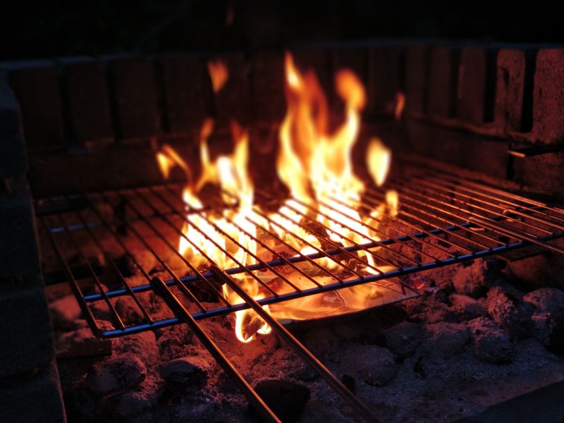 A fire pit with a frill over the flames