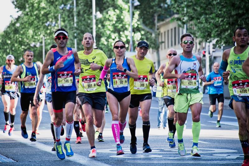 Image of runners in a race wearing a variety of clothing appropriate for running. 