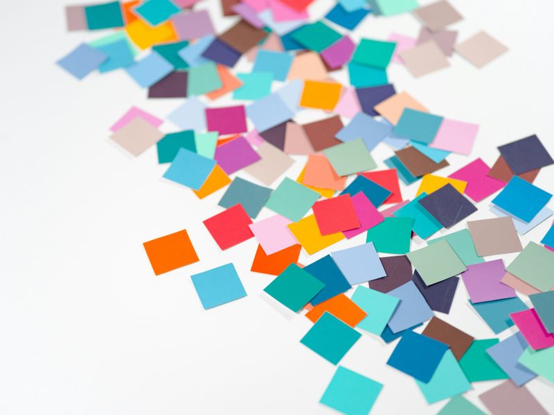 Colored sticky notes scattered on a desk.