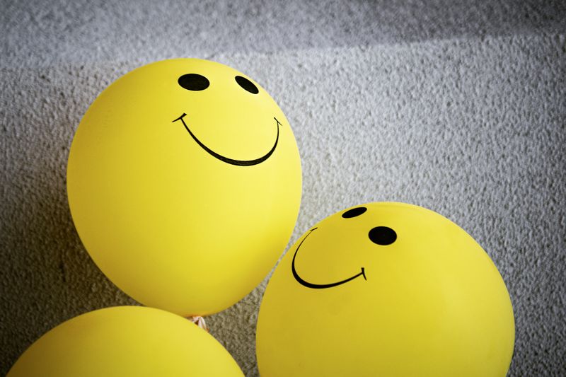 Yellow balloons with smiley faces.