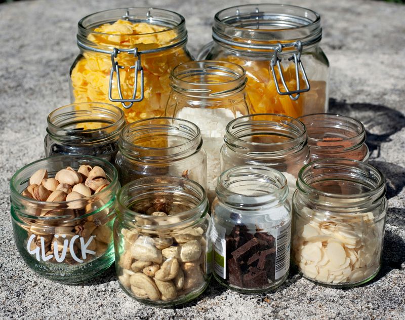 Different sized open jars with different food items inside