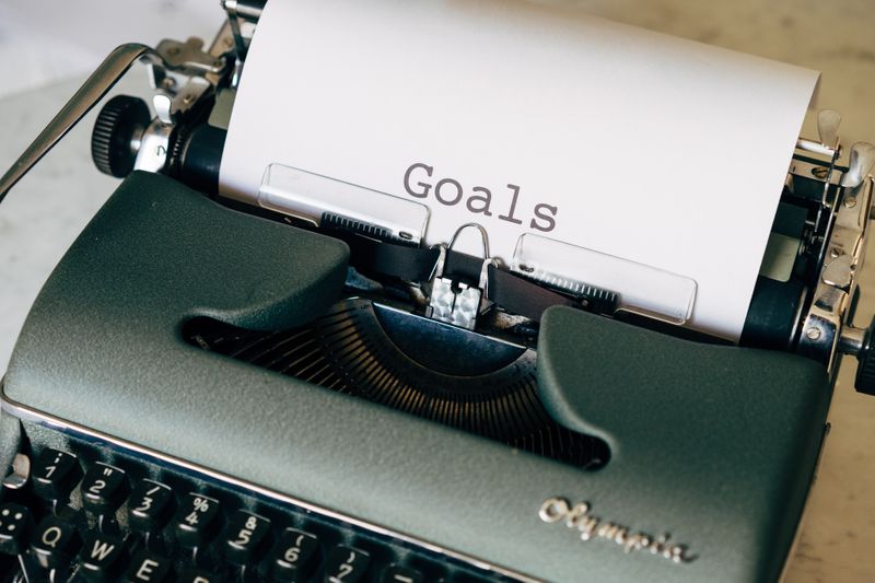 A typewriter with “Goals” printed on a piece of paper. (Photo by Markus Winkler on Unsplash)