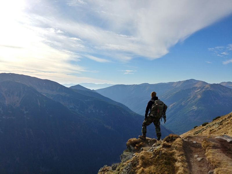 A person standing on top of a mountain.