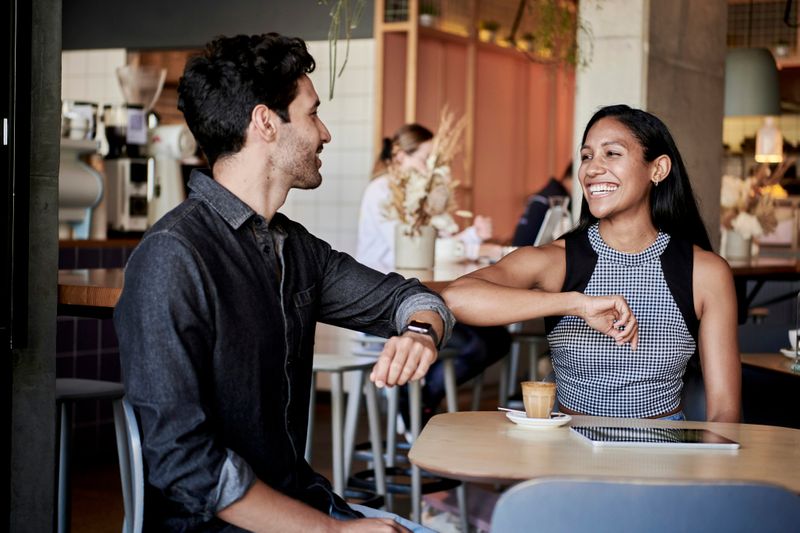 A young man and woman enjoying  a date at a restaurant.