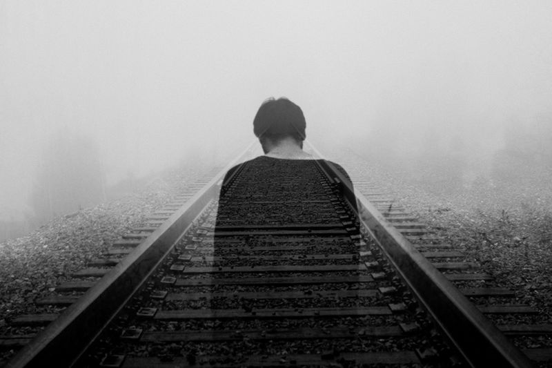 Shadow of a person walking on a railway track