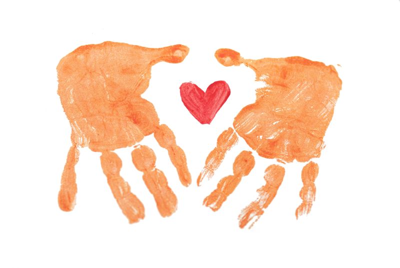 2 painted hand prints and a painted red heart in the middle.