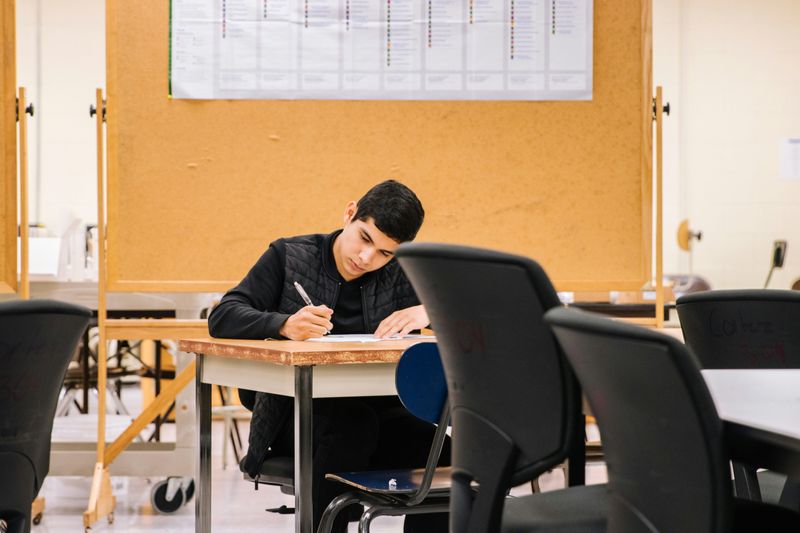 A student taking an exam at a desk.