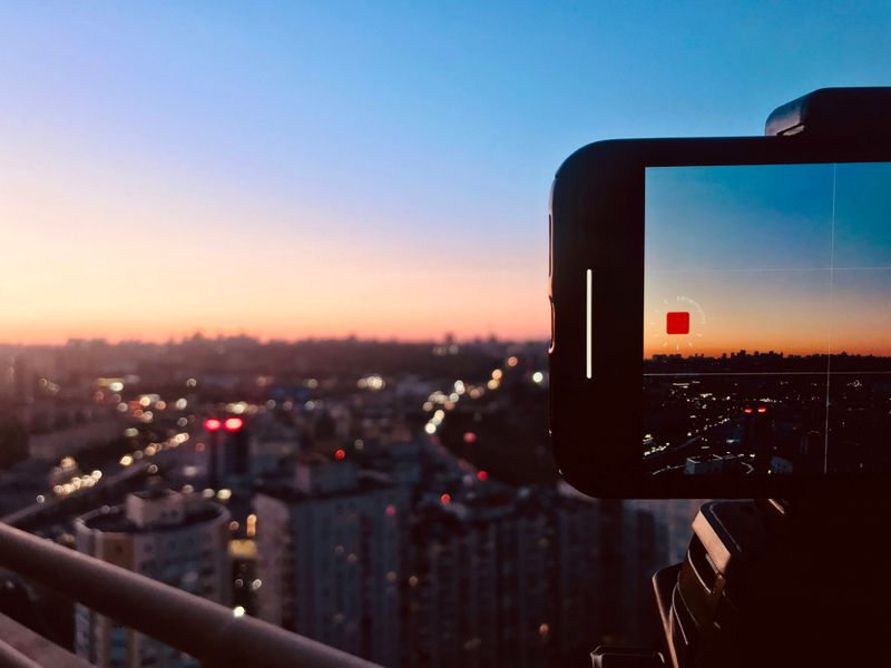 A camera recording a city skyline.