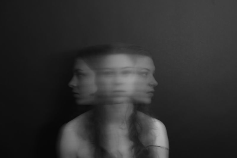 Image of a woman out of focus appearing to have three heads.