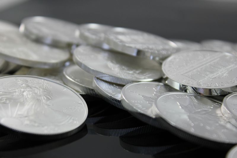 A close-up image of a pile of silver dollar coins. 