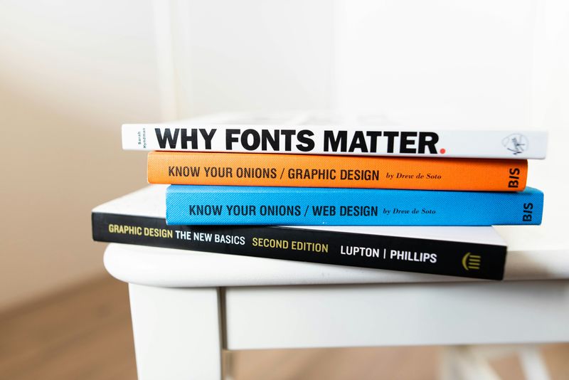 A stack of books about fonts and graphic design.