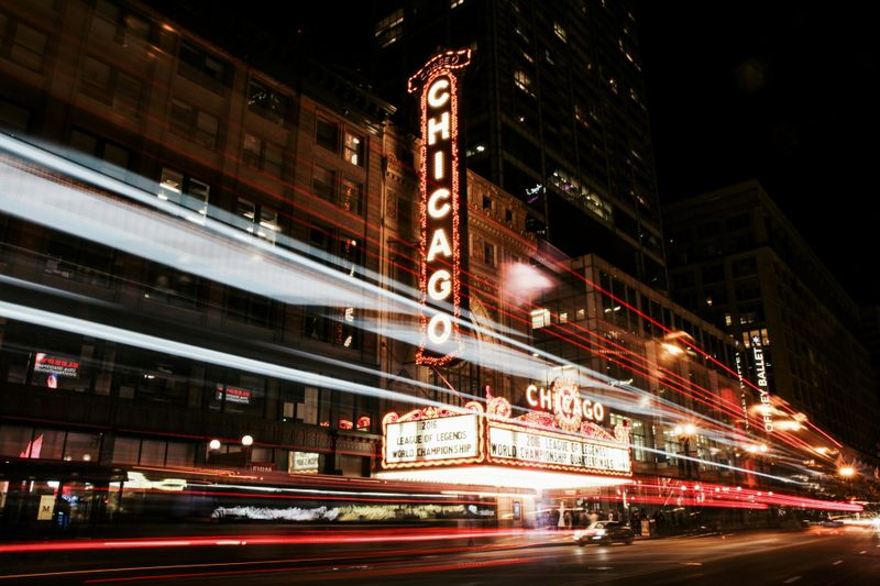 It's nightime, there is a theater that has a big sign that's light up and says Chicago