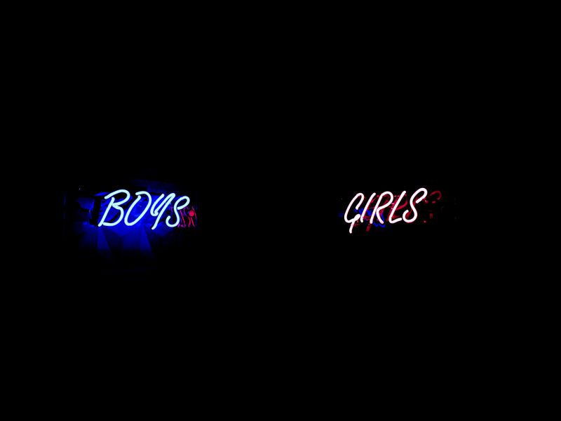 gender identity vs gender role: Neon sign reads 'Boys' in blue, 'Girls' in pink.