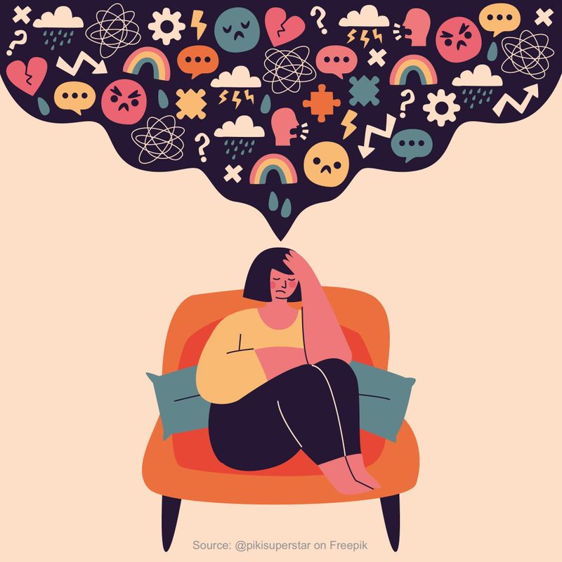 Woman sitting in a chair thinking with cloud containing emotion-related multiple symbols above her 