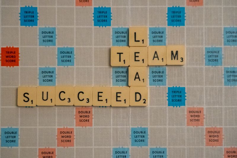 Scrabble letters that say lead, team, succeed