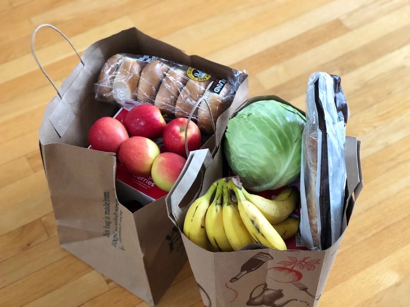 Two paper bags filled with groceries.