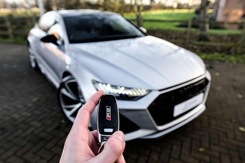 A new car with the keys in hand.