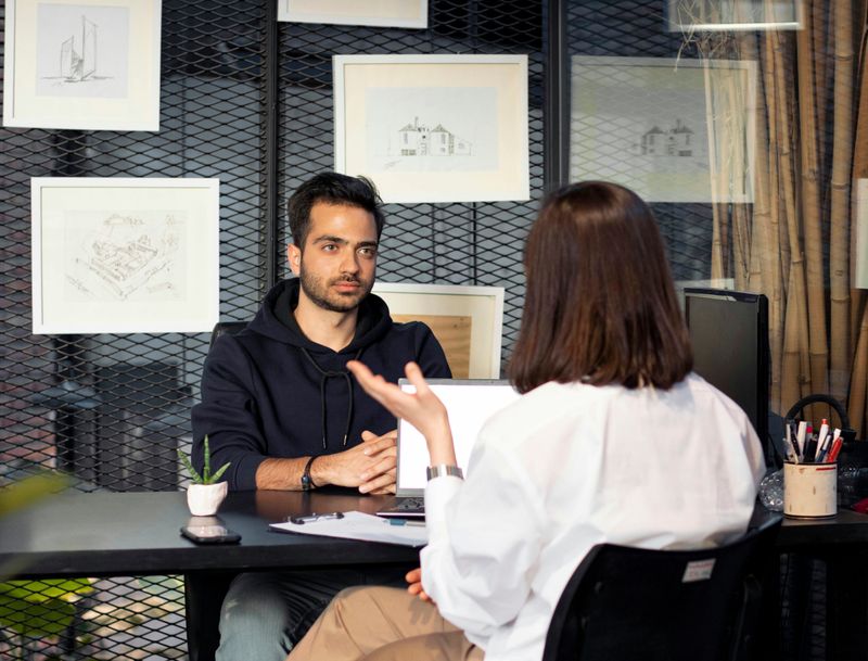 Two people talking to each other in an informational interview.