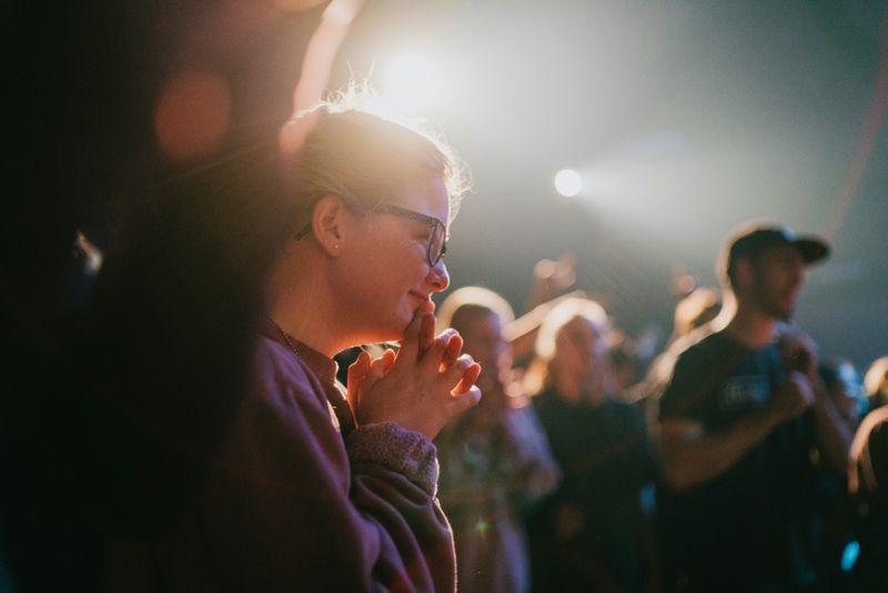 A woman praying in a church.