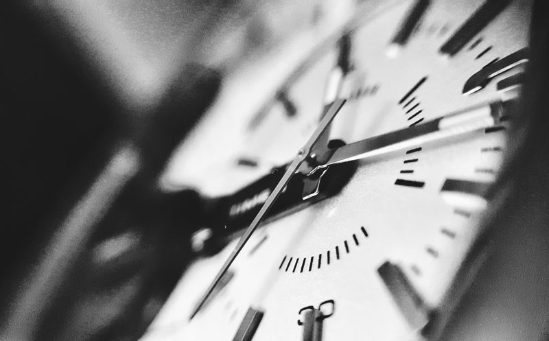 A close-up of a watch face with Roman numerals.
