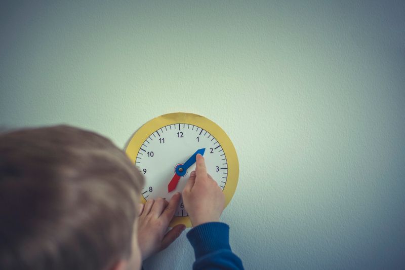 A child playing with a toy clock.