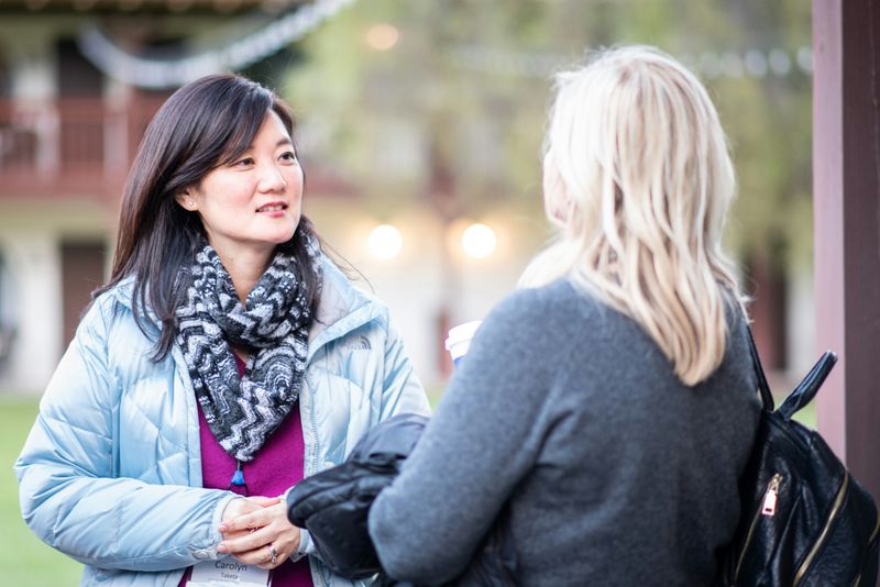 Two women talking to each other.