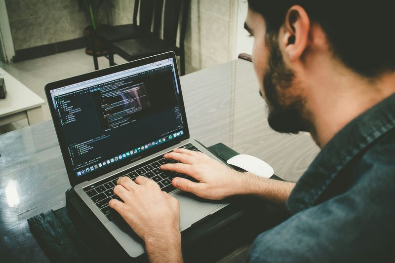 A man learning to code on their computer.