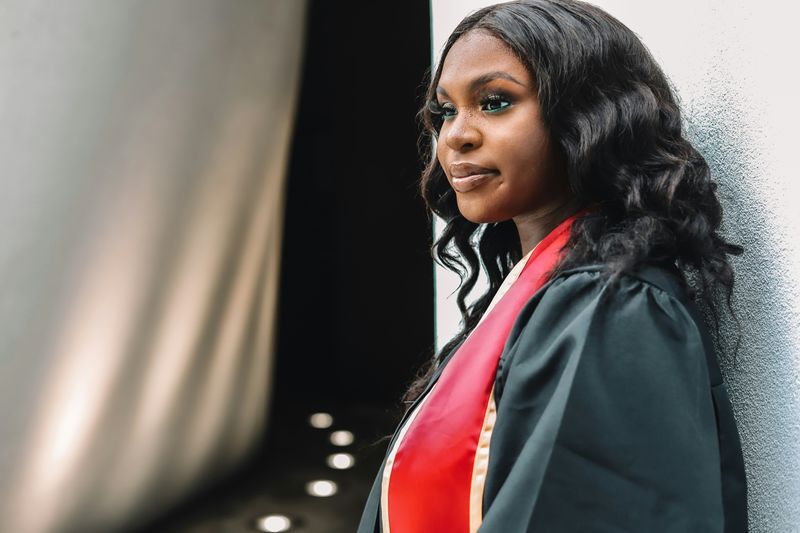 A woman in a graduation gown.