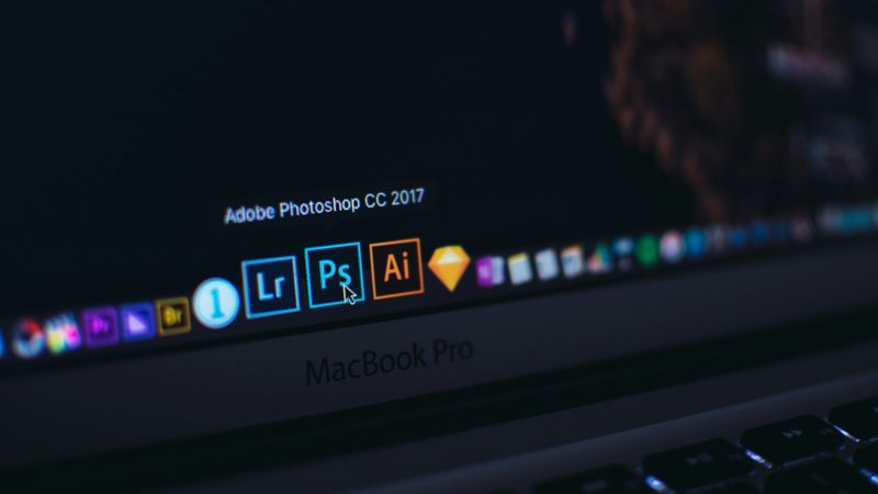 Hovering mouse on Adobe software launch icons on a computer screen