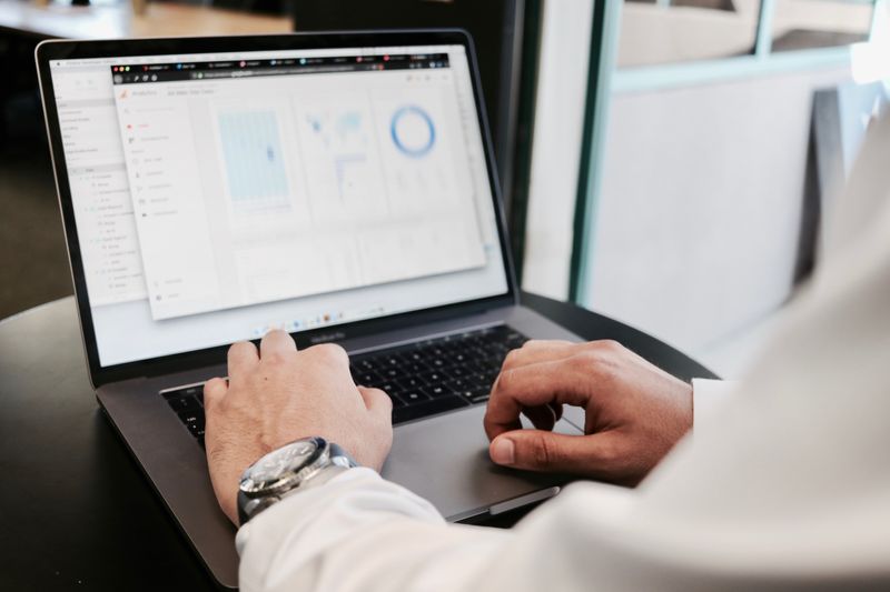 A business analyst looking at data on a laptop.