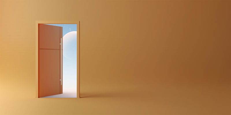 An isolated open door on a yellow backdrop. 