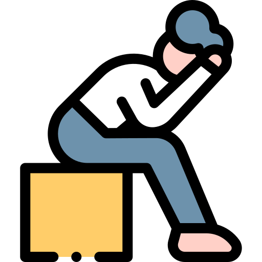 An icon of a person sitting on a box with their head in their hands