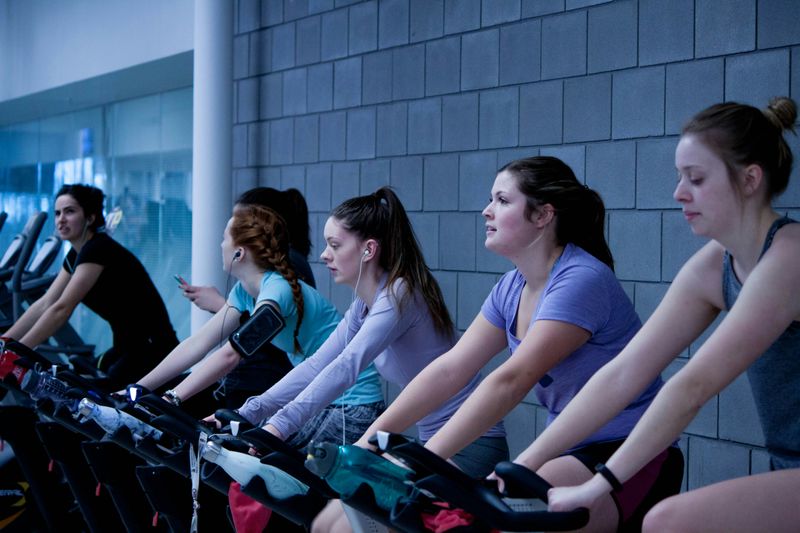 A few women participating in a spin class.