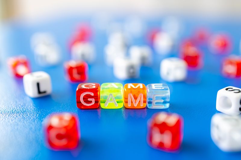 Dice, with the letters G,A,M, and E