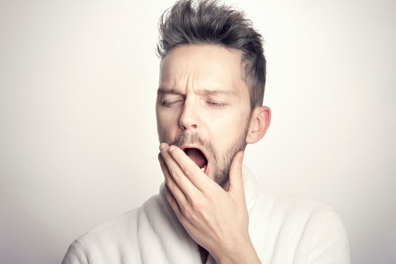 Image of a man yawning.