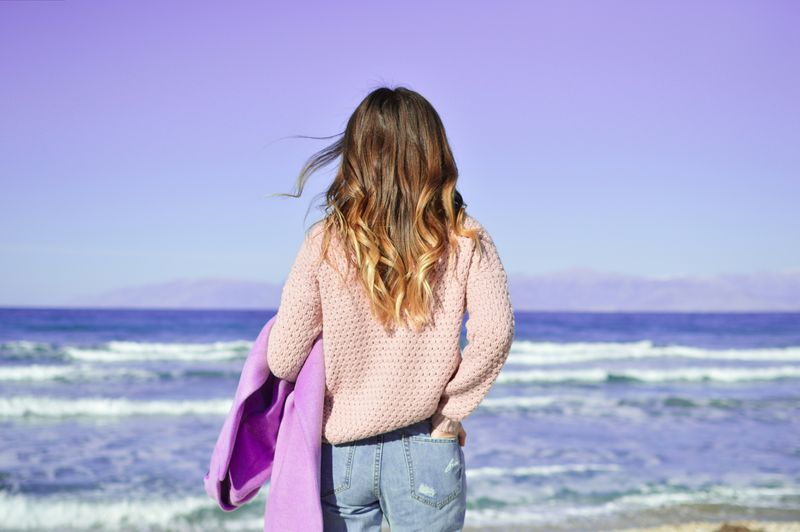 A young woman staring at the sea. 