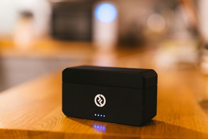 A wireless microphone sitting on a desk.