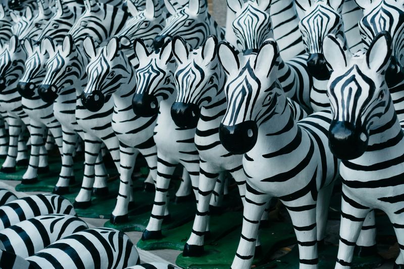 Lines of zebra statues that all look the same.