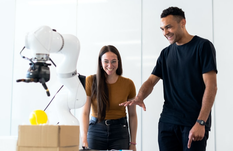 Two people testing a robotic device.