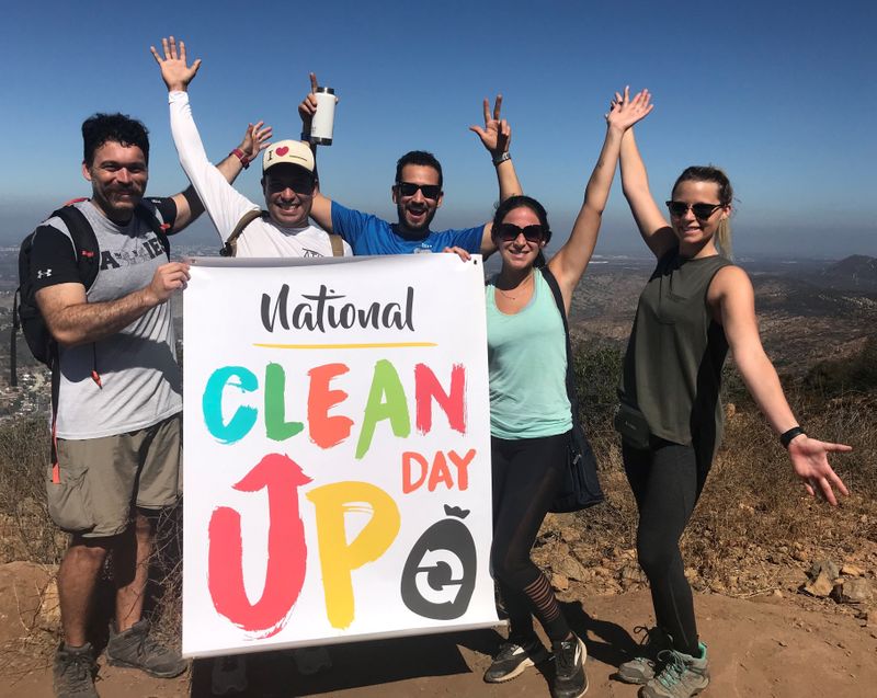 National Clean Up Day volunteers holding up a sign.