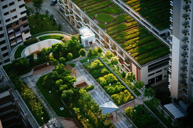 A building complex with green roofs and gardens.