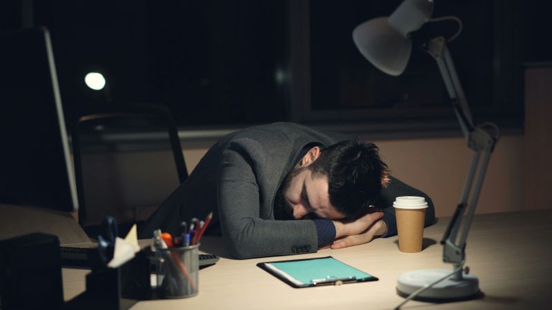 A man looking tired and fed up due to stress.