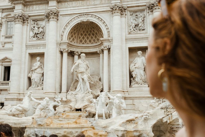 A women looking at the Trevi Fountain in Rome, Italy.