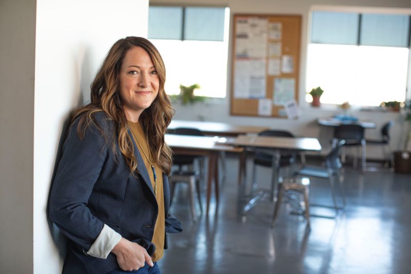 teacher standing at door of classroom