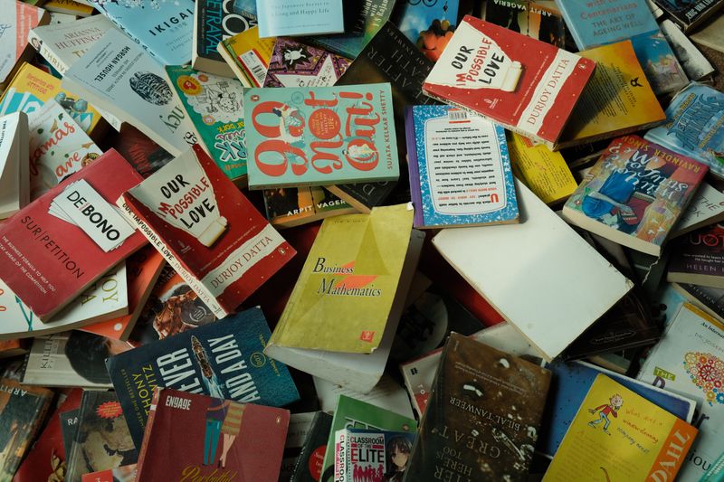 A pile of books on the ground.