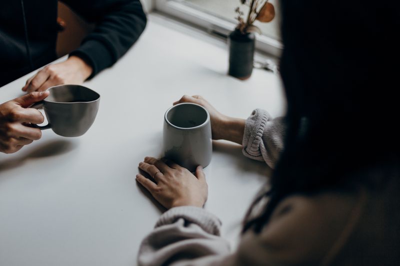 Two people discussing something over coffee