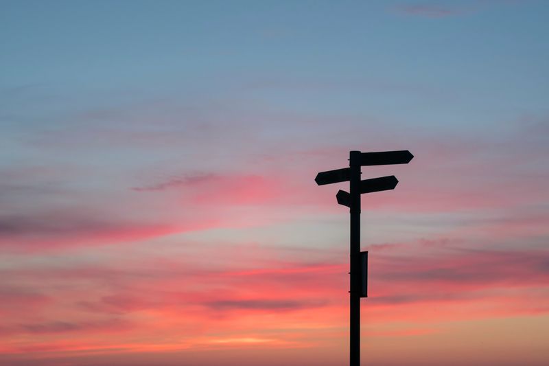 Sunset with a directional road sign