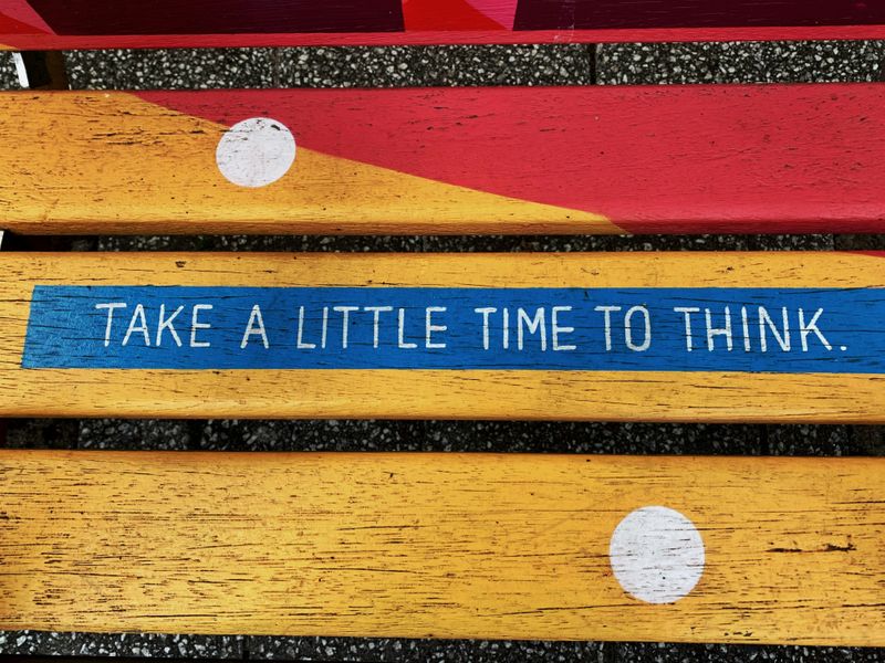 The words 'Take a little time to think' written on a mural.