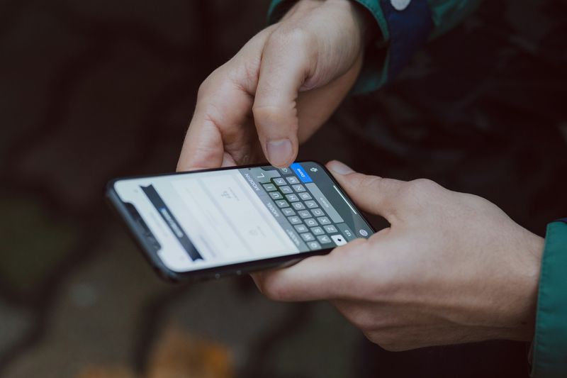 A person typing out a message on a phone.