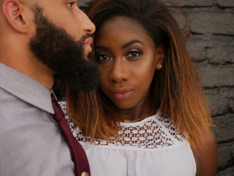 A man and a woman facing in different directions appearing unhappy or discontent. 